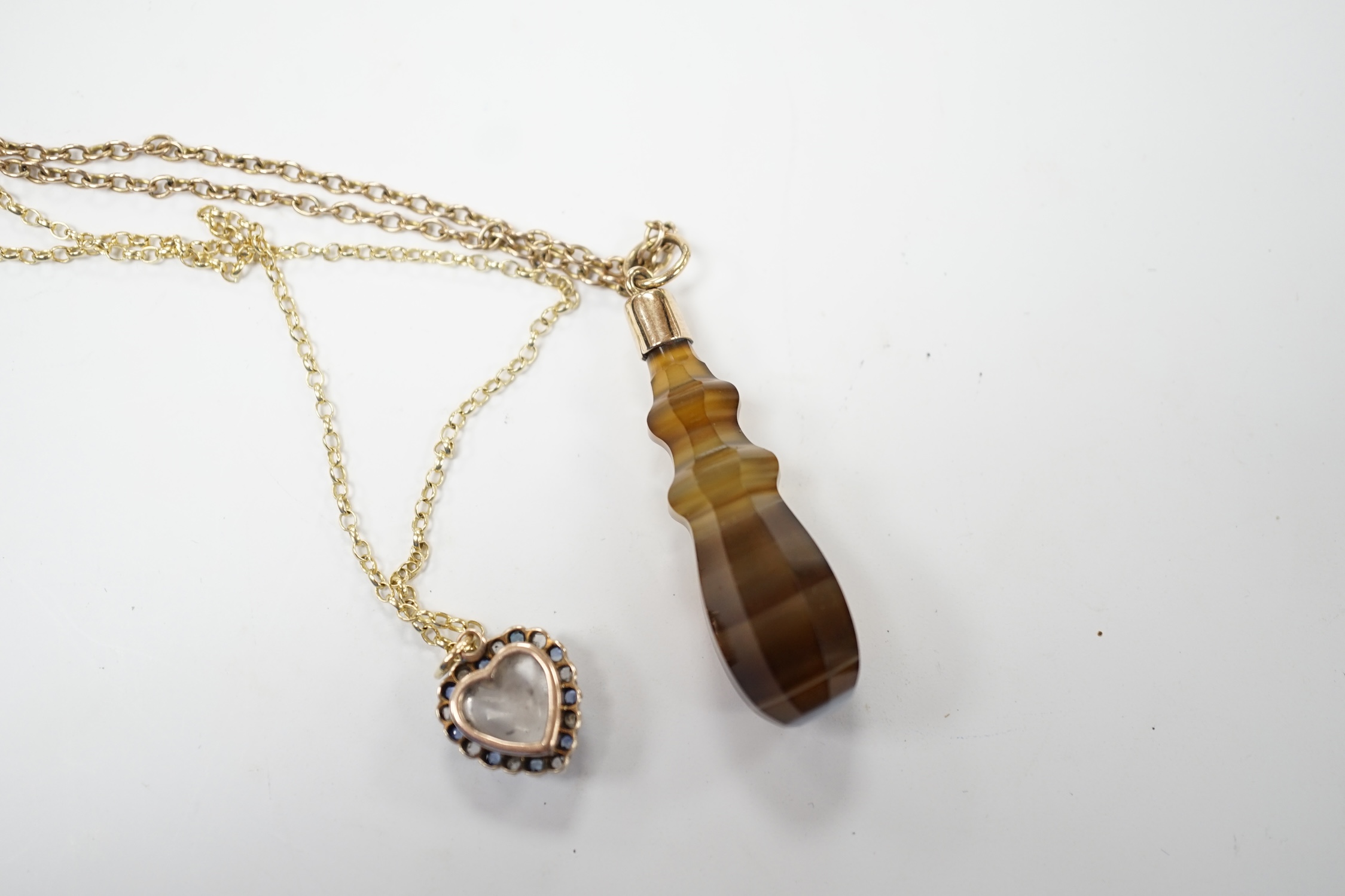 An early 20th century yellow metal, moonstone, sapphire and rose cut diamond set heart shaped pendant, 12mm on a yellow metal chain, together with a yellow metal mounted banded agate pendant, on a 9c chain. Fair conditio